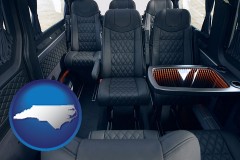 north-carolina map icon and black leather seats in a customized van