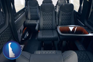 black leather seats in a customized van - with Delaware icon