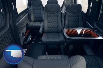 black leather seats in a customized van - with Oklahoma icon